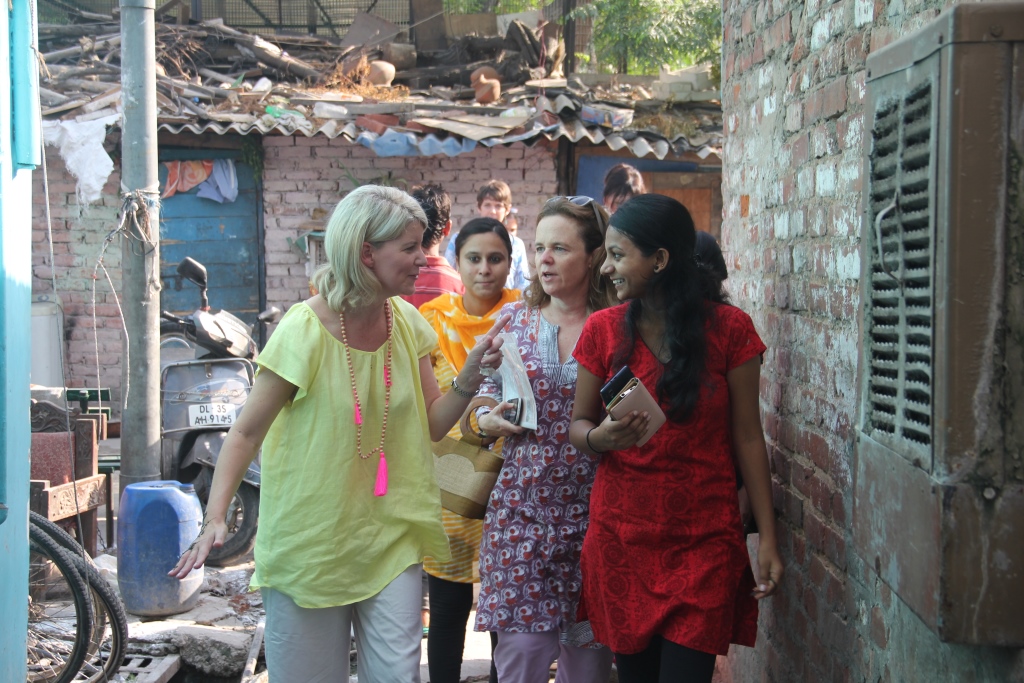 Ms Despoja talks to Babita (in red) on her way to Babita’s home in the slum
