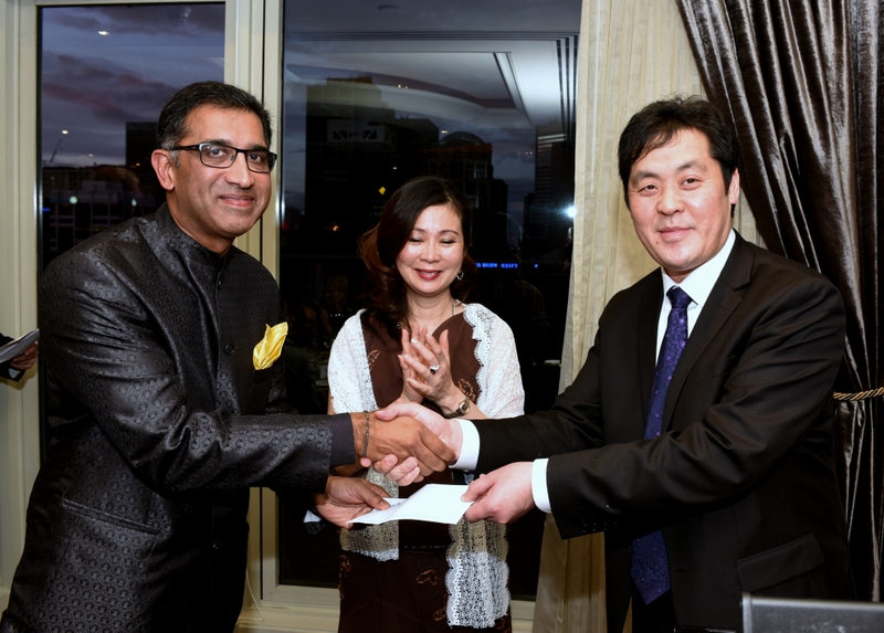 Richard Wong and Grace Lim from the Asian Executive present a cheque accepted by Harish Rao on behalf of the Australian Friends of Asha.