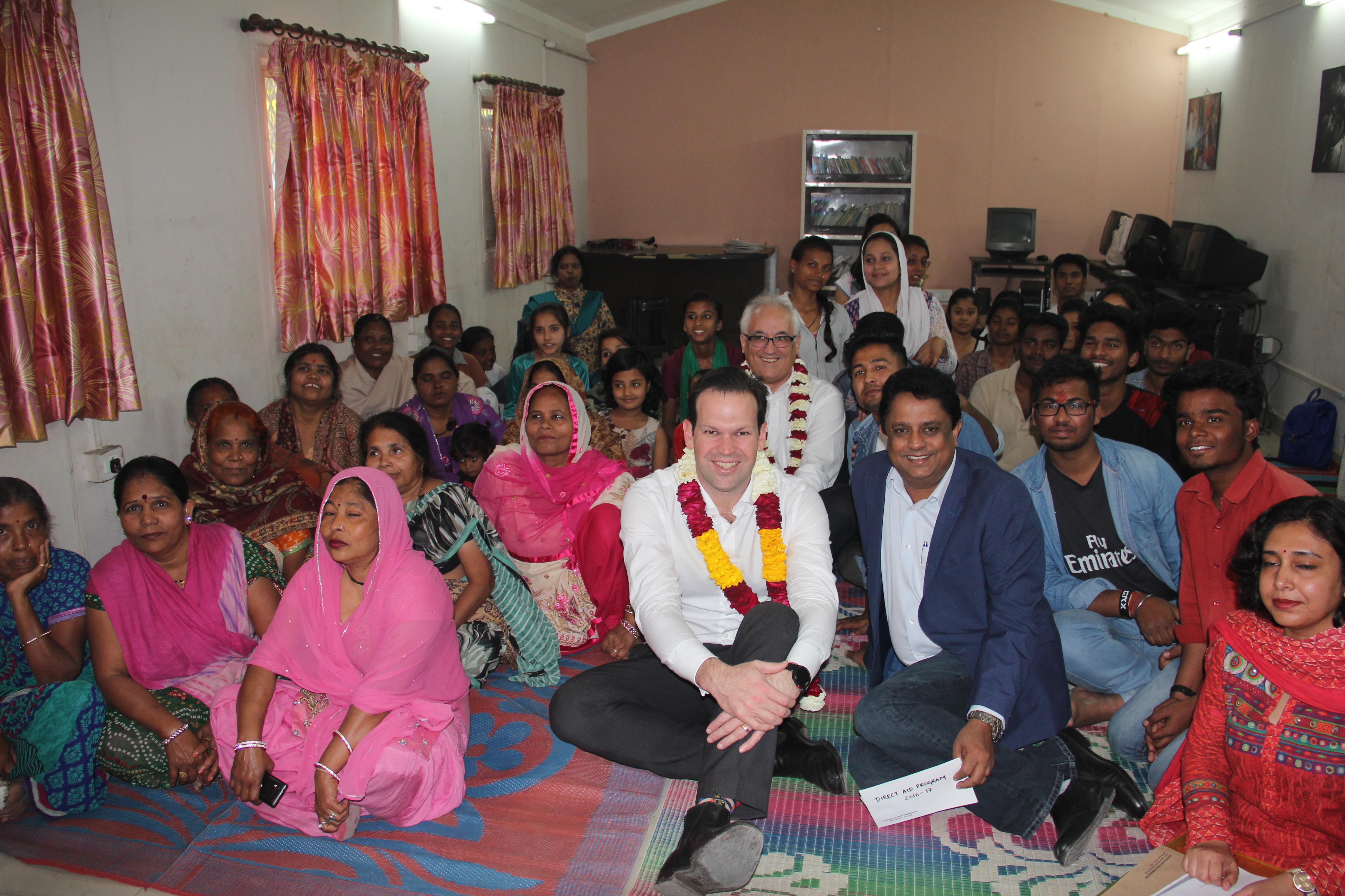 Mathew Canavan and Freddy Martin pose for a group picture with the Asha community