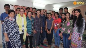 Dr Monica and her parents posing with Asha students and Ms Rani (L), Asha Supervisor