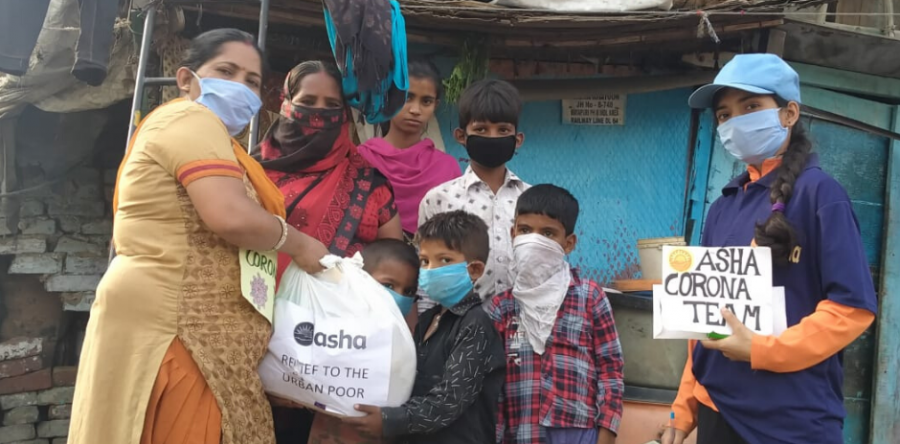 Slum families receive groceries in the Asha slums